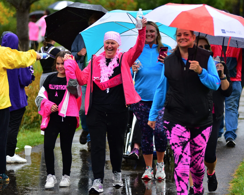 Group of people walk with umbrellas at CRC's 29th Annual Walkathon